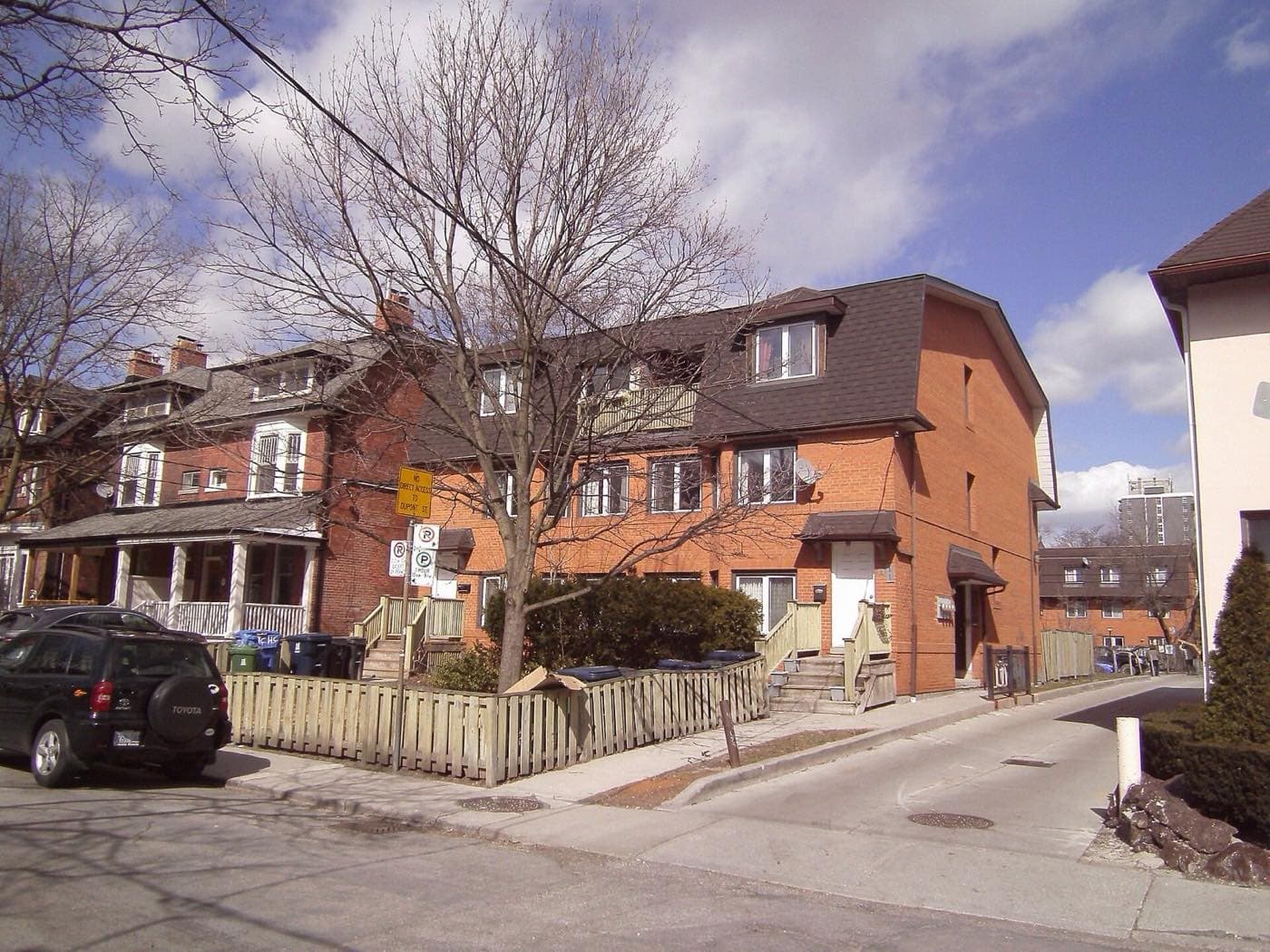 A pair of semi-detached brick Victorian houses with porches