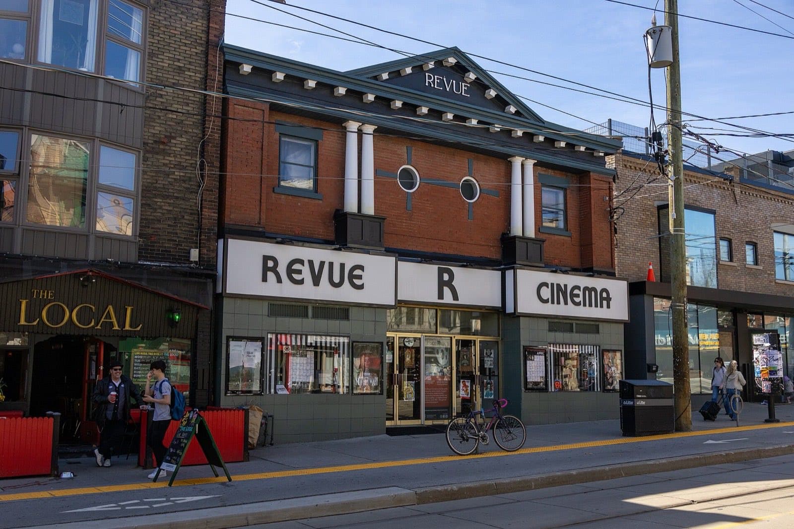 An old cinema with a marquee, on a shopping street