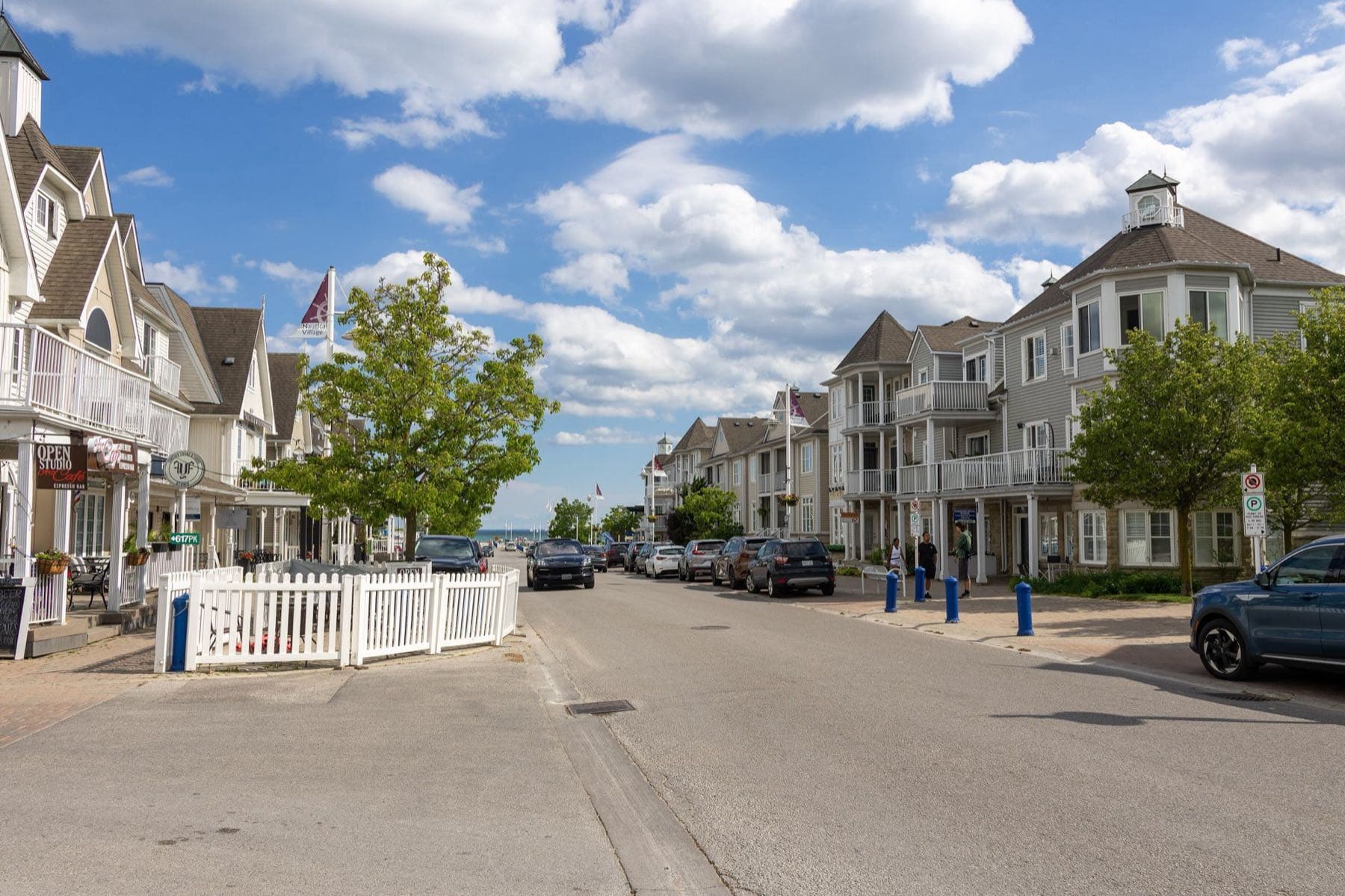 A street of white gabled townhouses in the Nautical Village by the lake